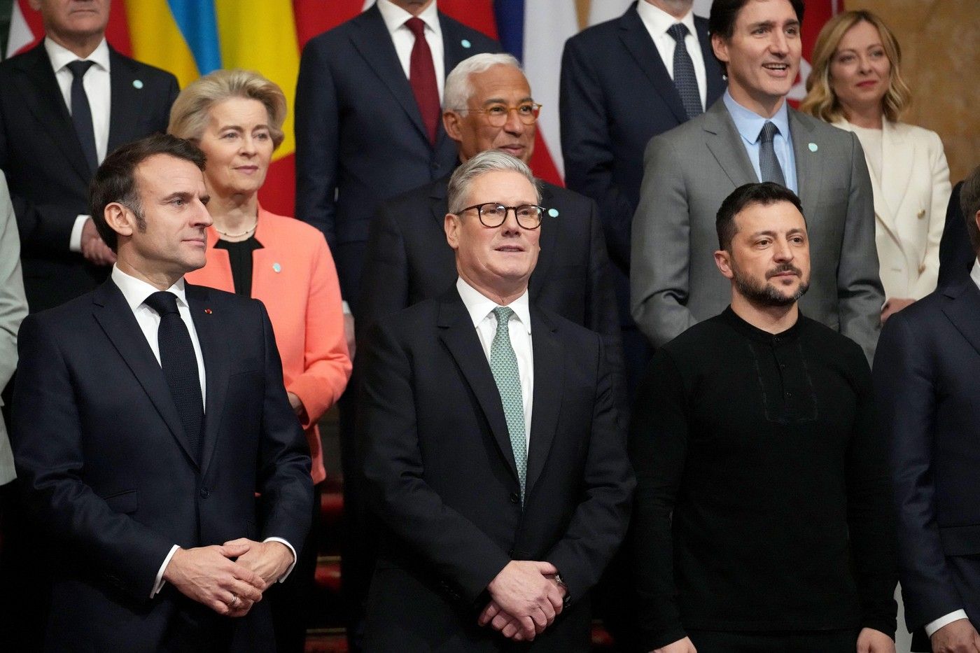 From left, French President Emmanuel Macron, Britain’s Prime Minister Keir Starmer and Ukraine’s President Volodymyr Zelenskyy pose during a group photo at a summit on Ukraine at Lancaster House in London, UK, on Sunday, March 2, 2025. Photo by Christophe