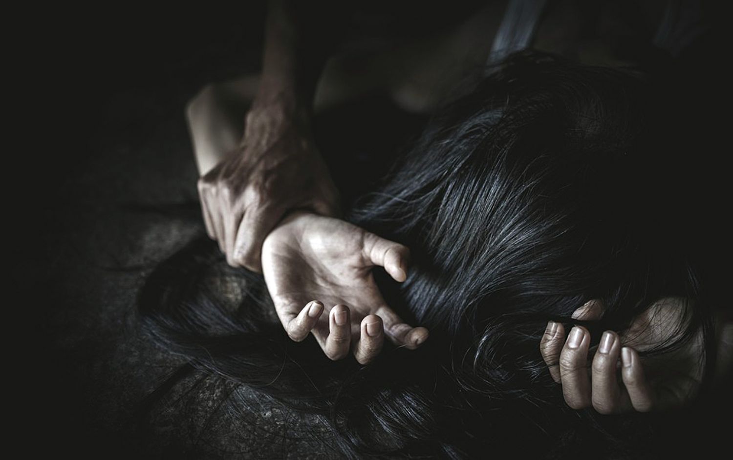 Man's hand holding a woman hand for rape and sexual abuse concept, Wound domestic violence rape, concept photo of sexual assault, International Women'