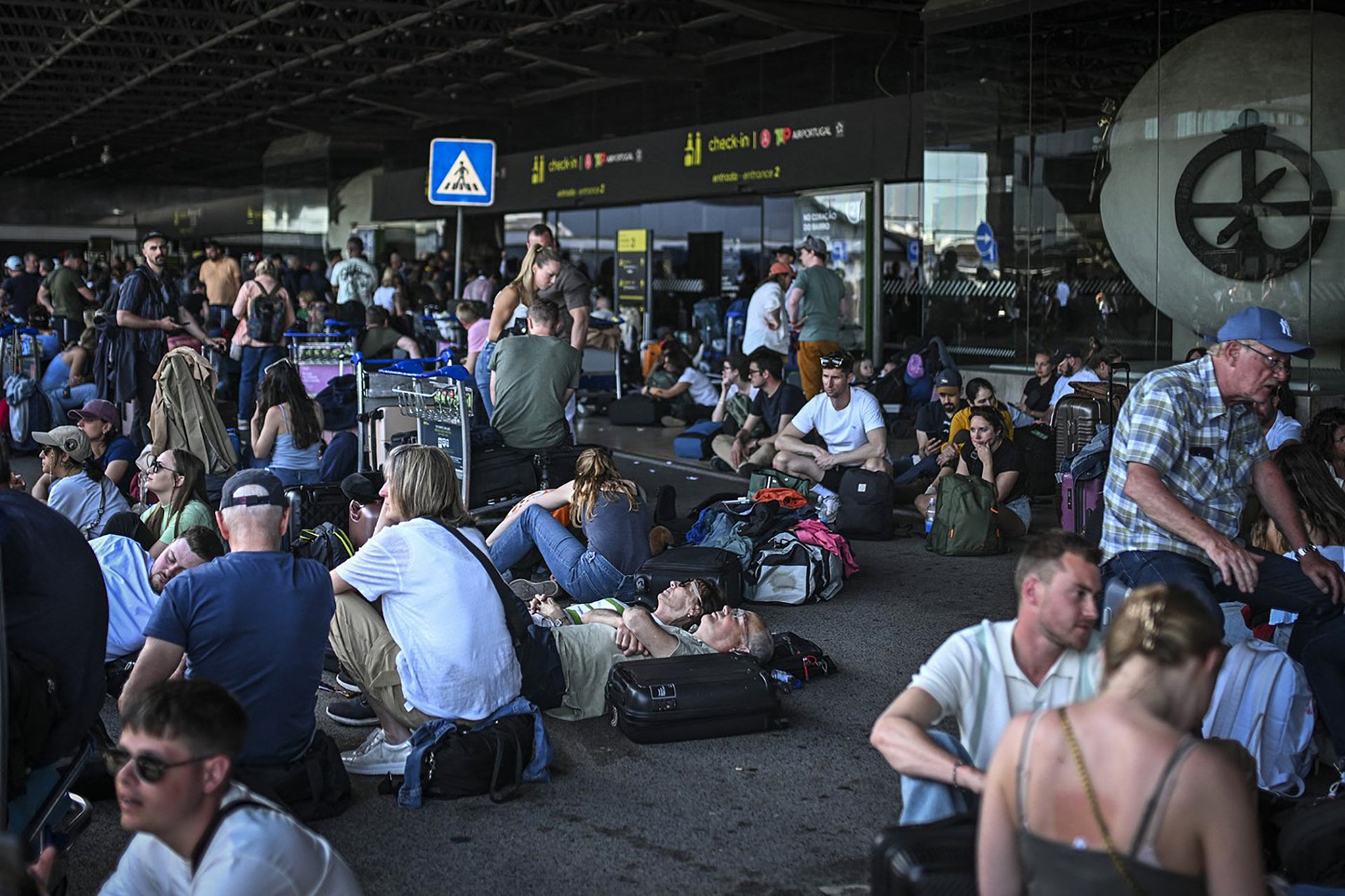 Čekající lidé před lisabonským Letištěm Humberta Delgada